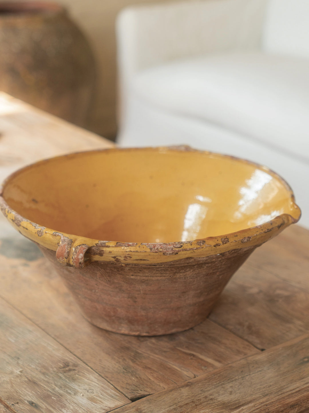 a yellow bowl is sitting on a wooden table .