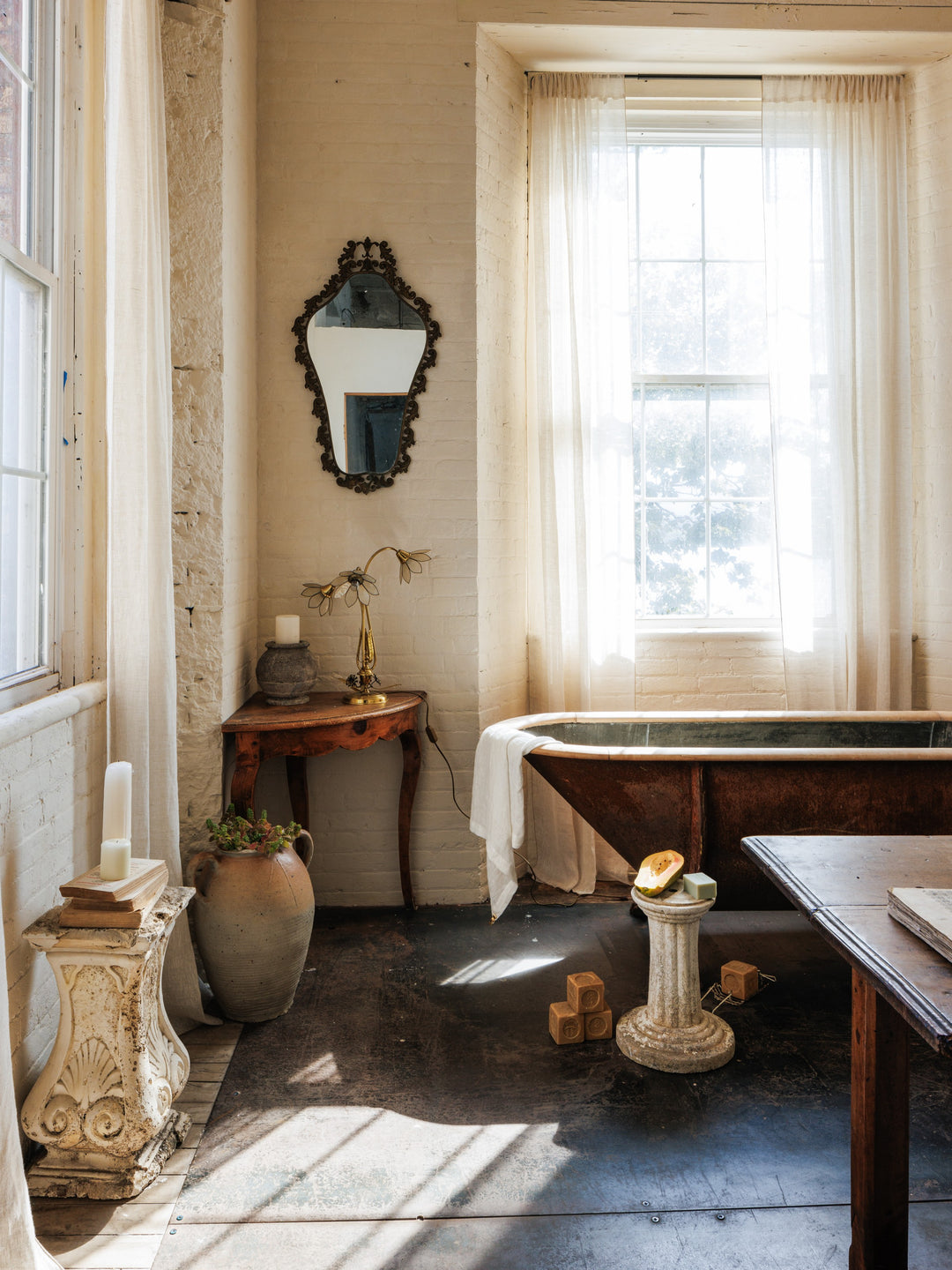 a bathroom with a wooden tub and a mirror