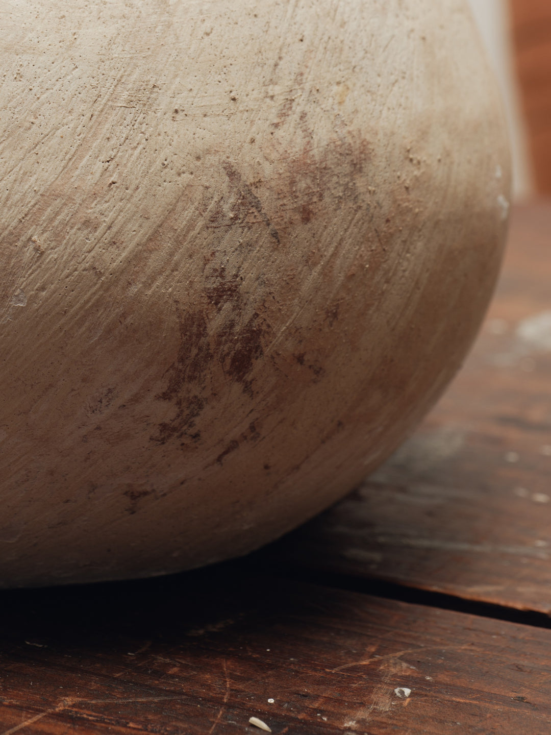 a close up of a clay pot on a wooden table .