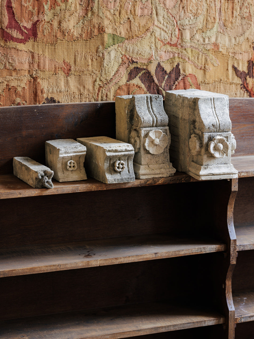 a wooden shelf with a few pieces of stone on it