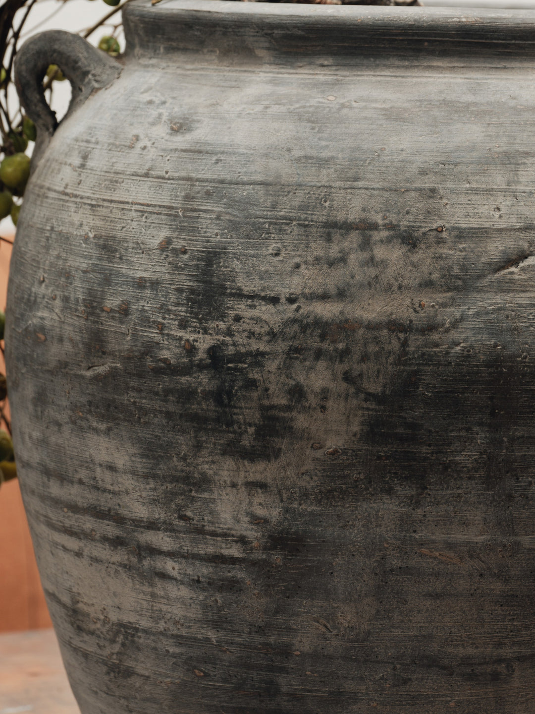 a large black pot with a handle is sitting on a table .