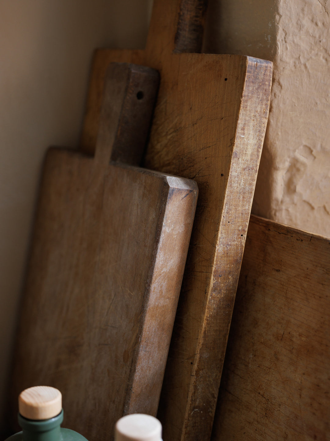 three wooden cutting boards are stacked on top of each other on a table .