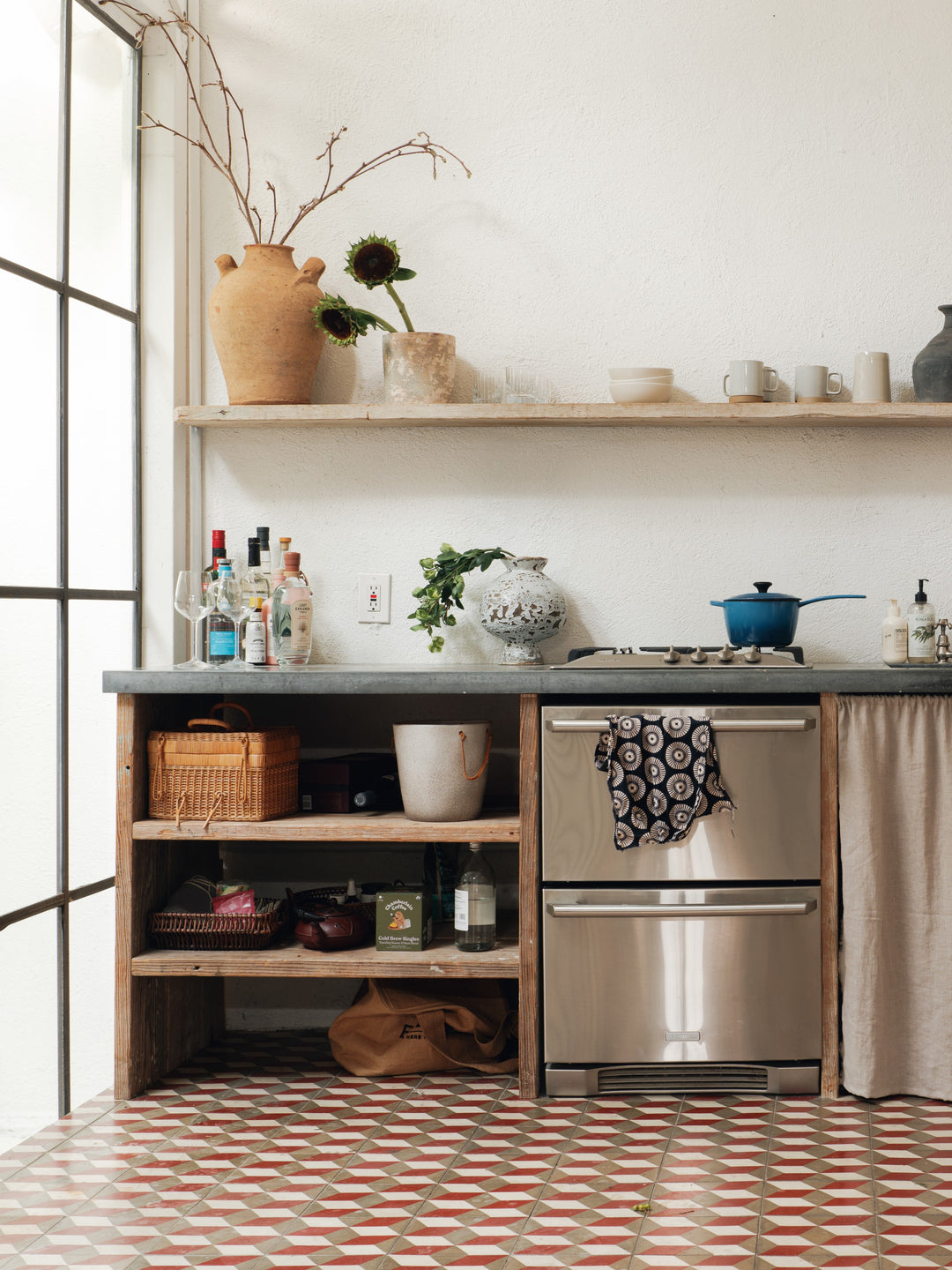a kitchen with a stainless steel appliance and a checkered floor