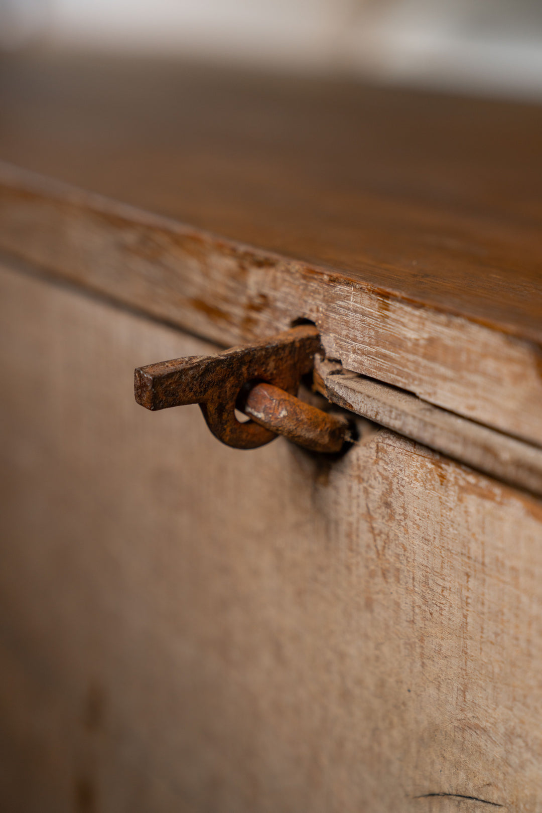 a close up of a rusty piece of metal on a wooden surface .