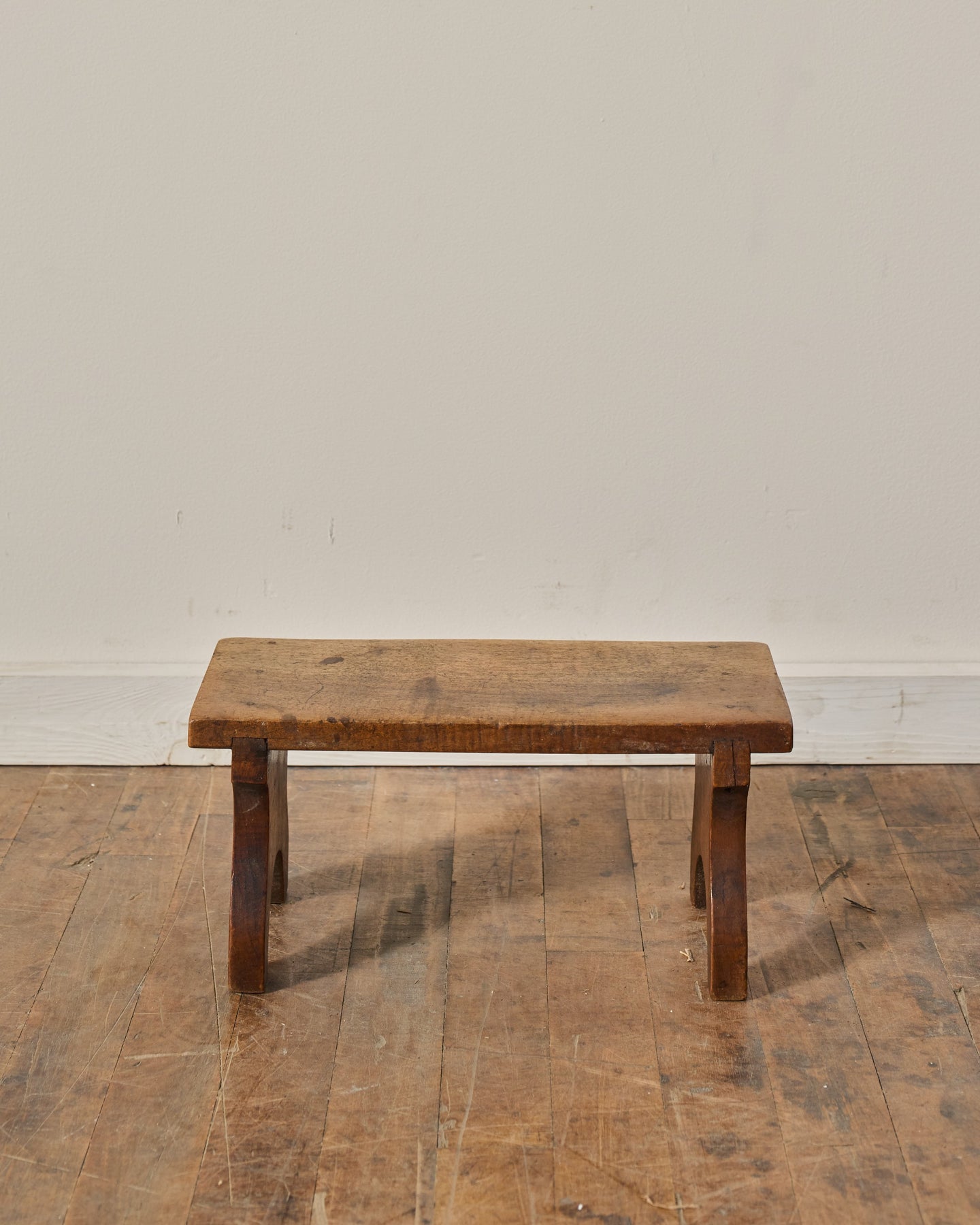 Small, rustic wooden stool.