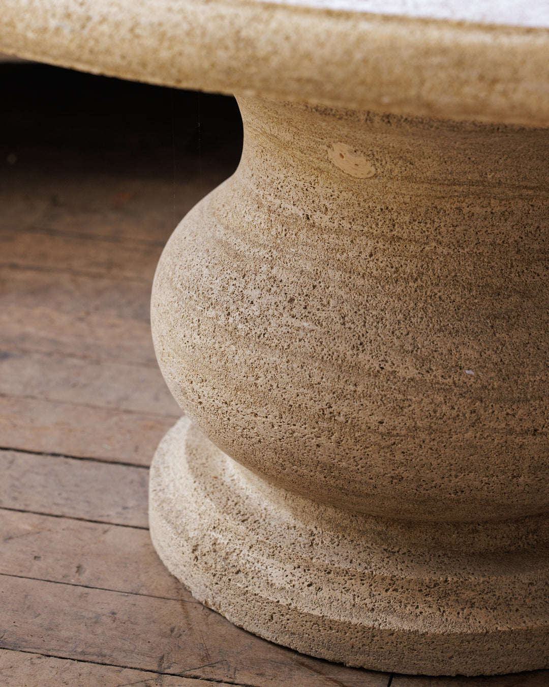 a close up of the base of a table on a wooden floor