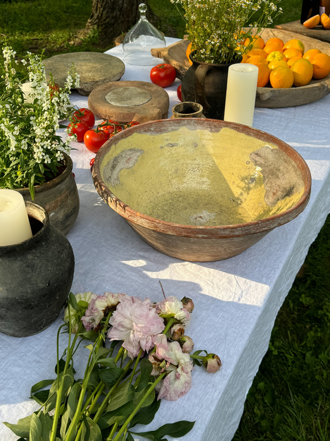 a table with a bowl of food and flowers on it