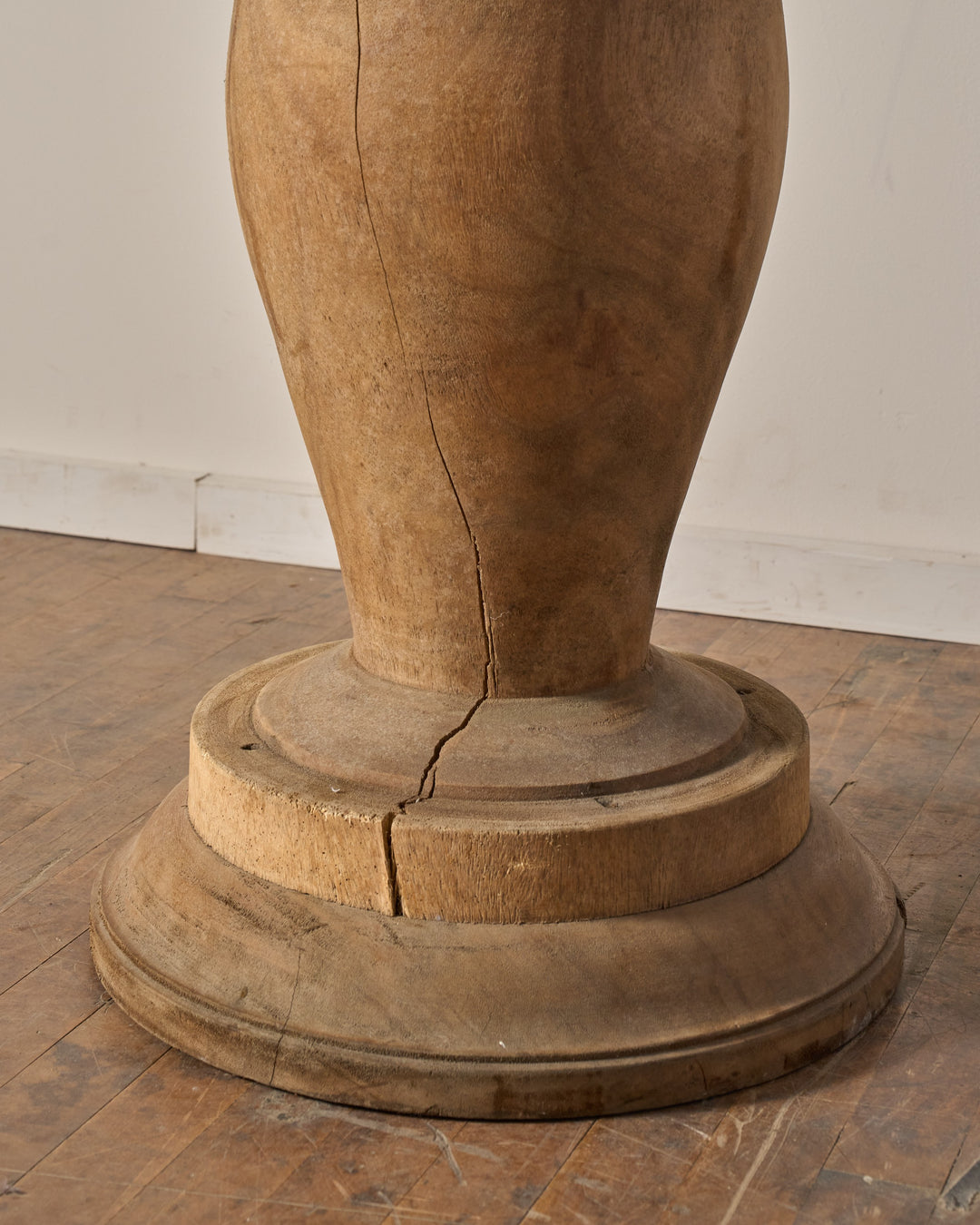 Cracked wooden pedestal base.