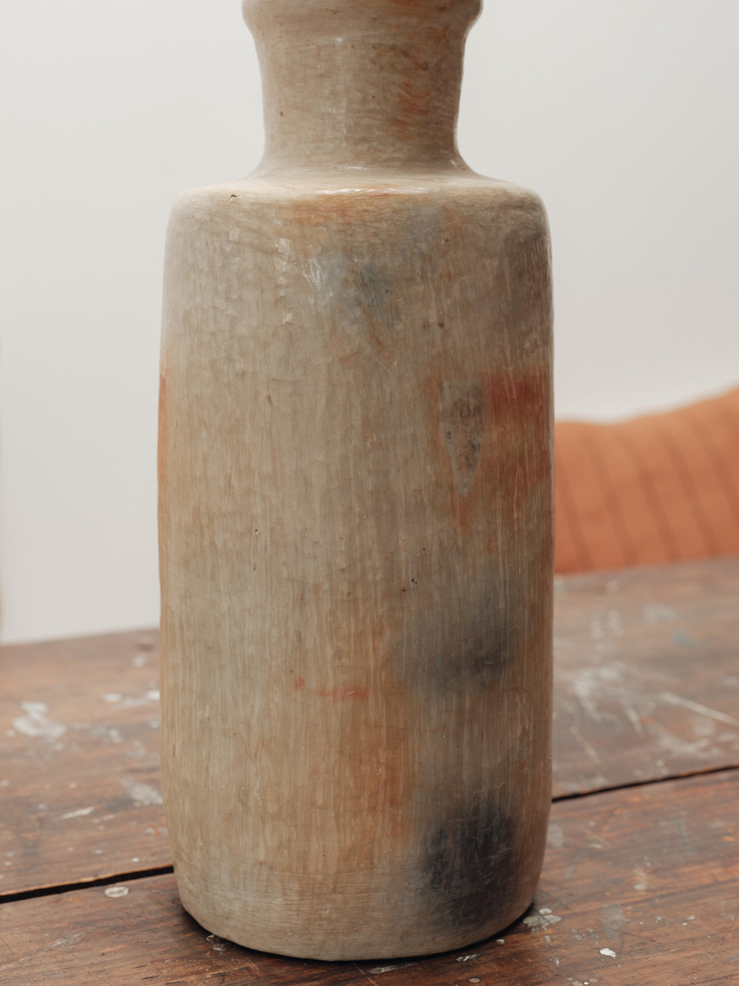 a wooden vase is sitting on a wooden table .