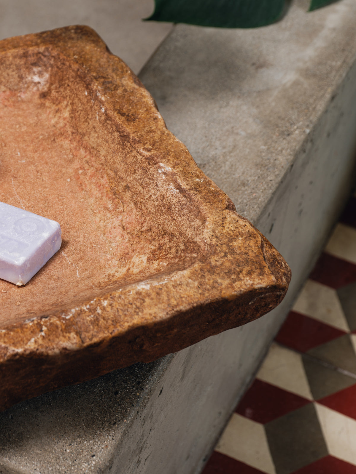 a piece of soap is sitting on top of a large rock .