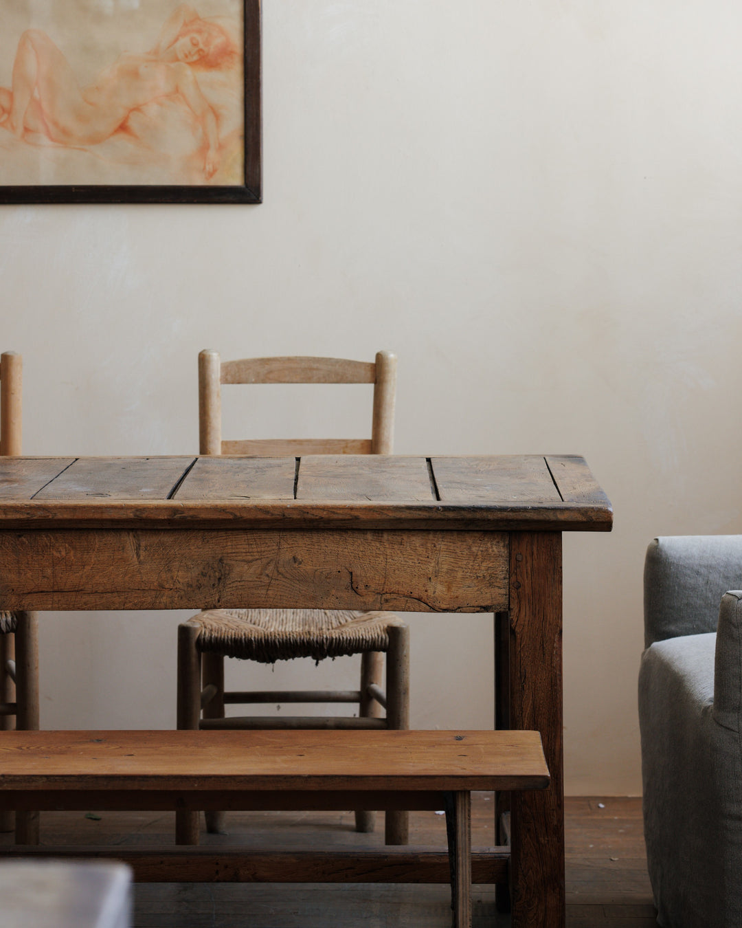 a wooden table with chairs and a bench in a living room
