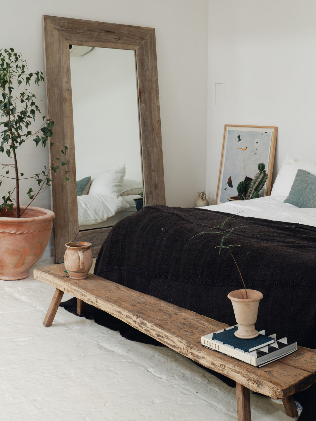 a bedroom with a large mirror on the wall above the bed