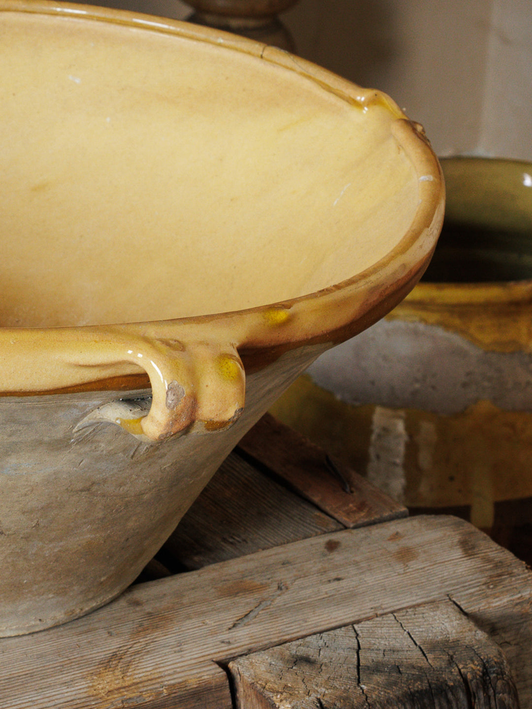 a bowl with a handle sits on a wooden table