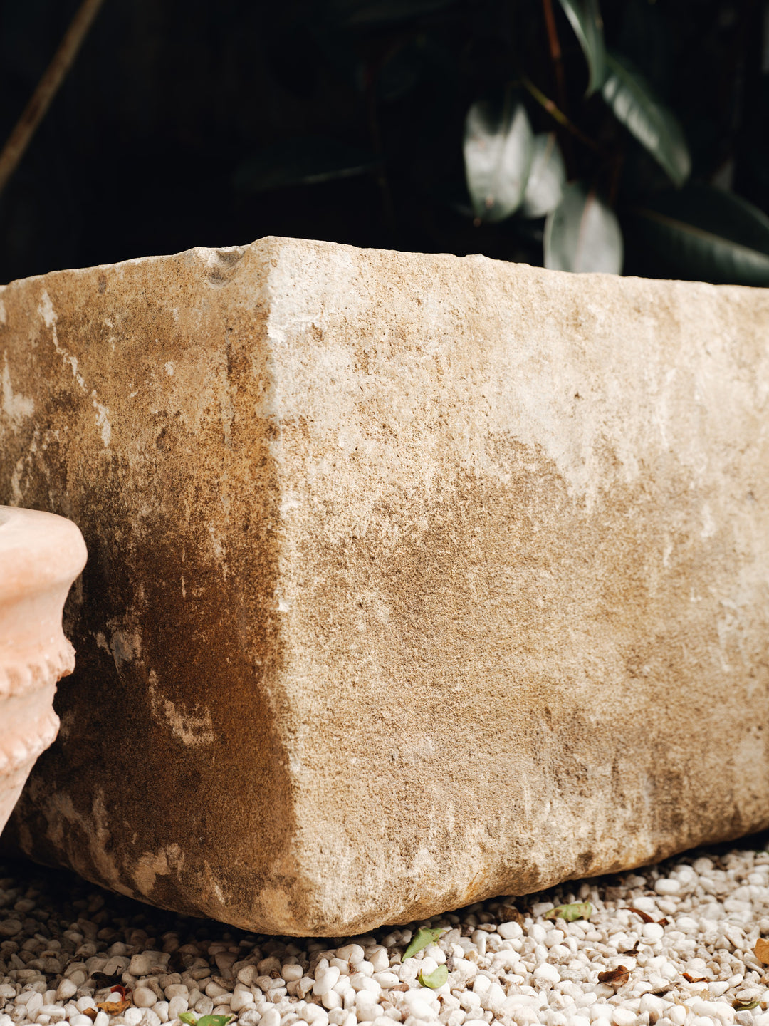 a large stone block is sitting on a pile of gravel