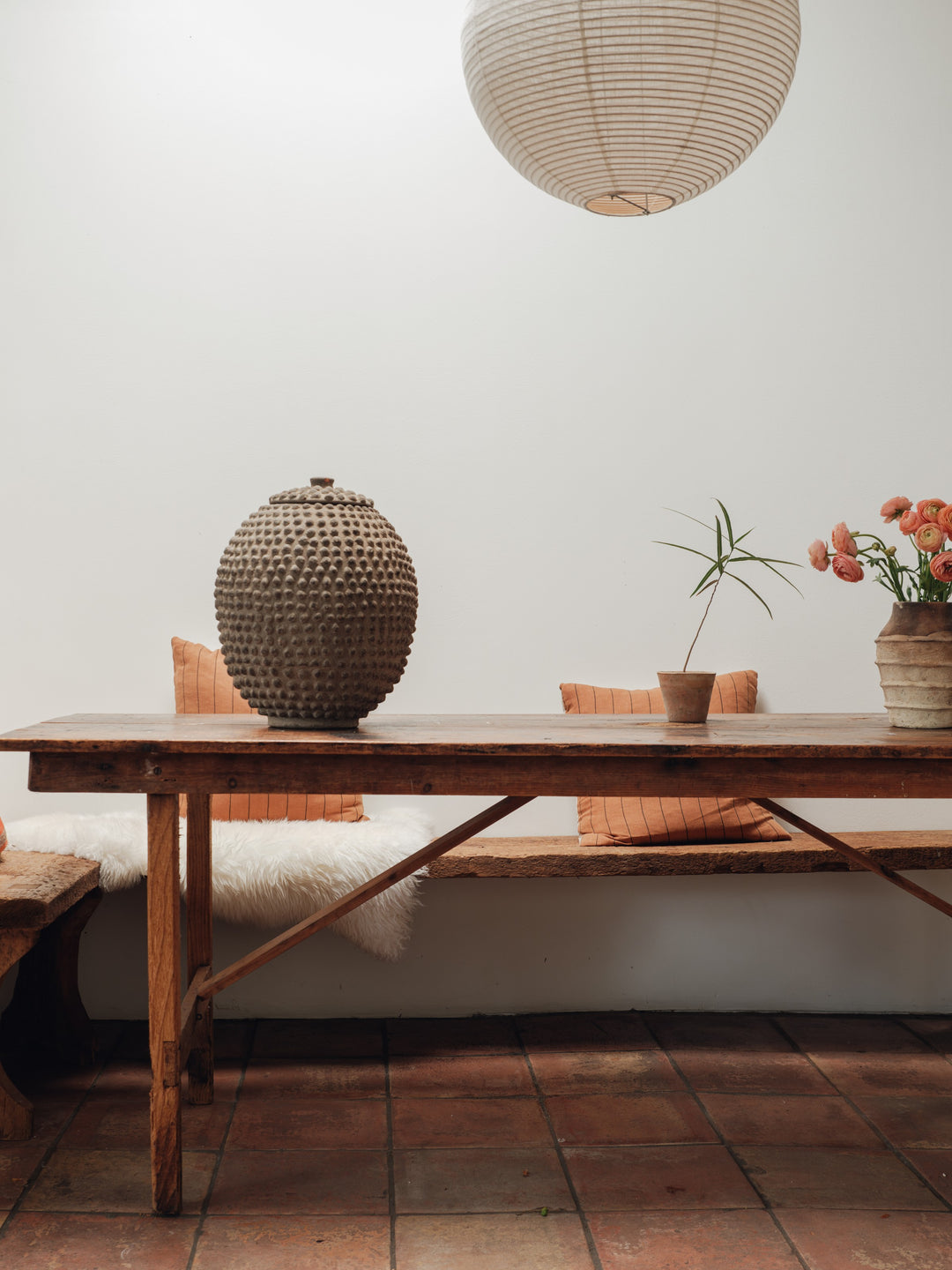 a wooden table with a vase on top of it in a room .