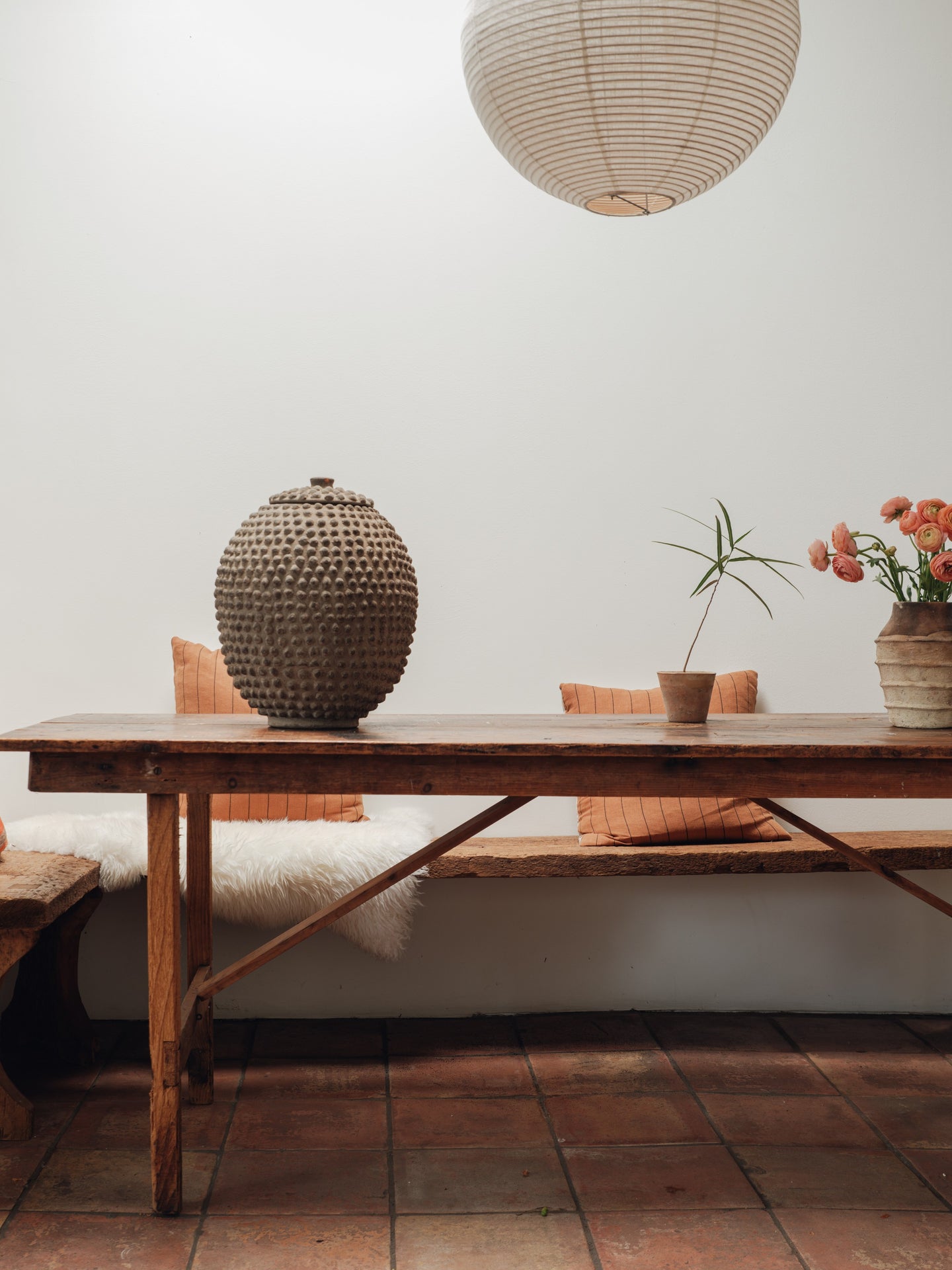 a wooden table with a vase on top of it in a room .