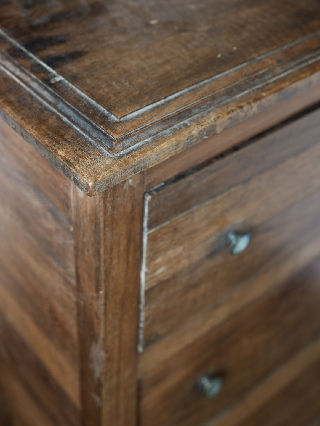 a close up of a wooden dresser with drawers