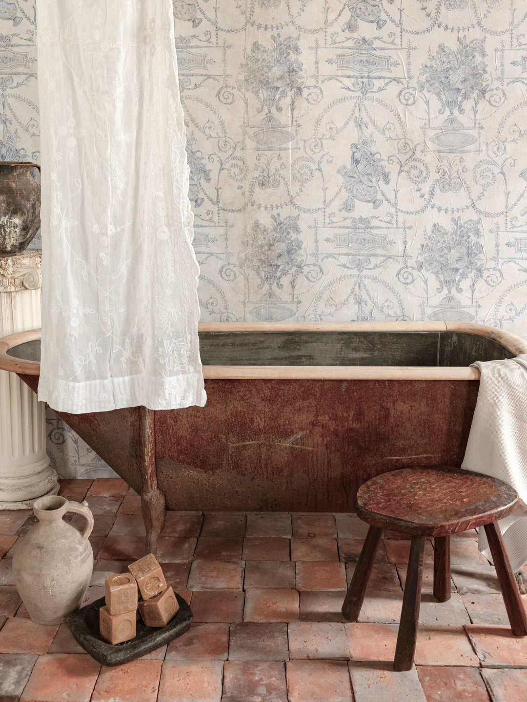 a bathtub in a bathroom with a white shower curtain