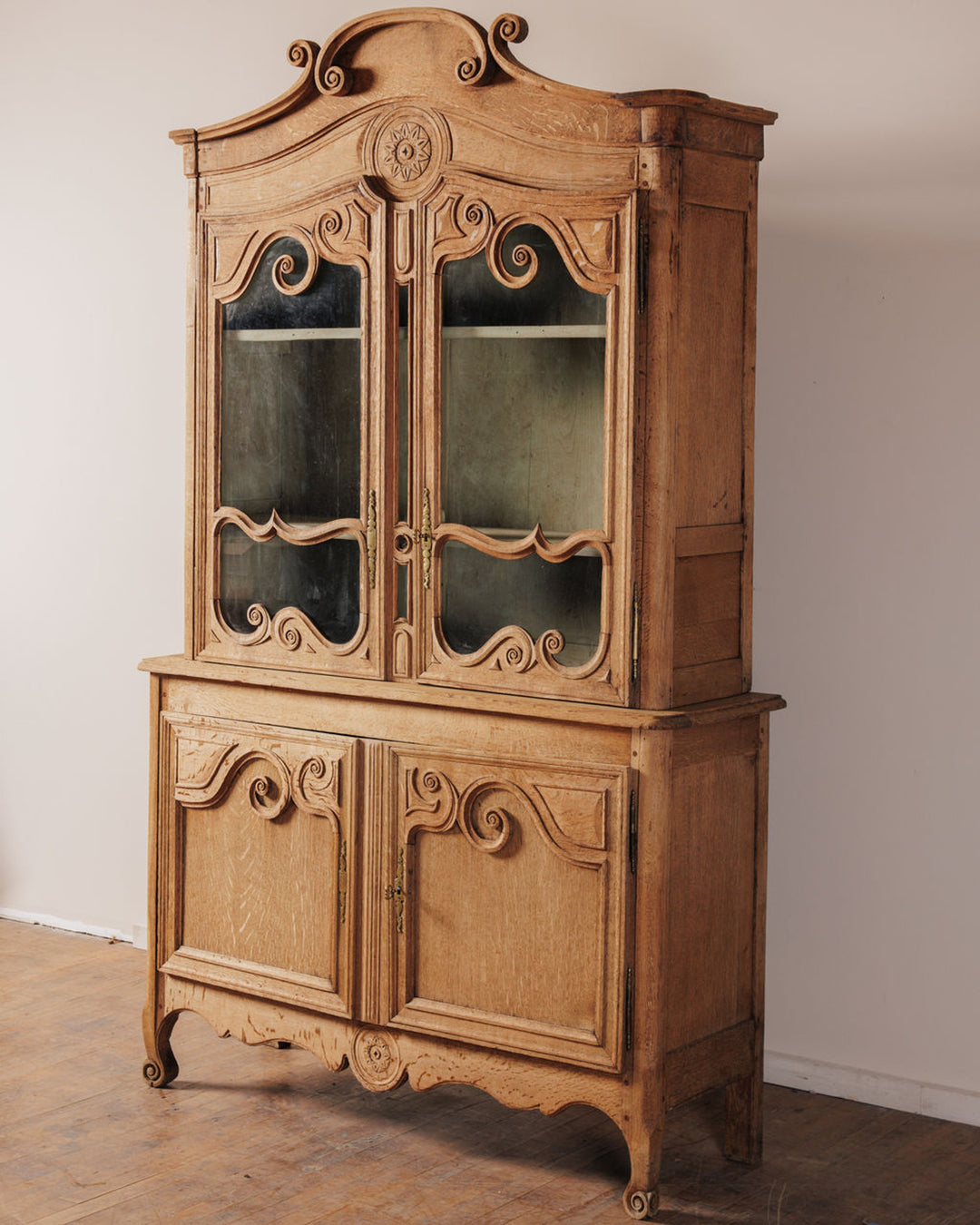 Ornate antique carved light wood display cabinet.
